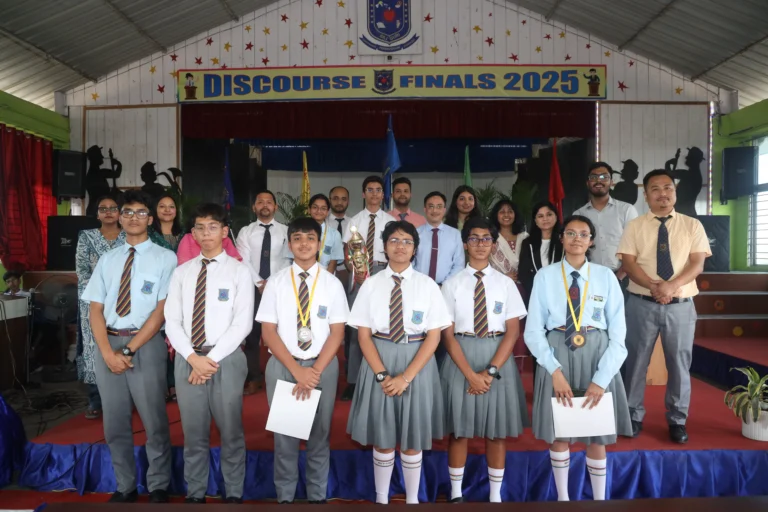 students lining up for a group photo after debate competion