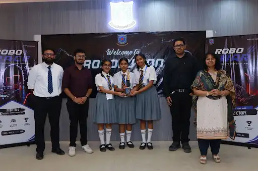 Sacred Heart School students receiving the Second Position trophy in the Innoverse: Future Innovation Project at Robolution 2026.