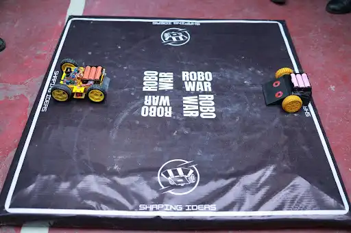 Two robots face off during the Robo War Competition at Robolution 2026.