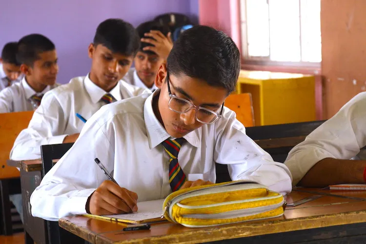 Student writing inside classroom